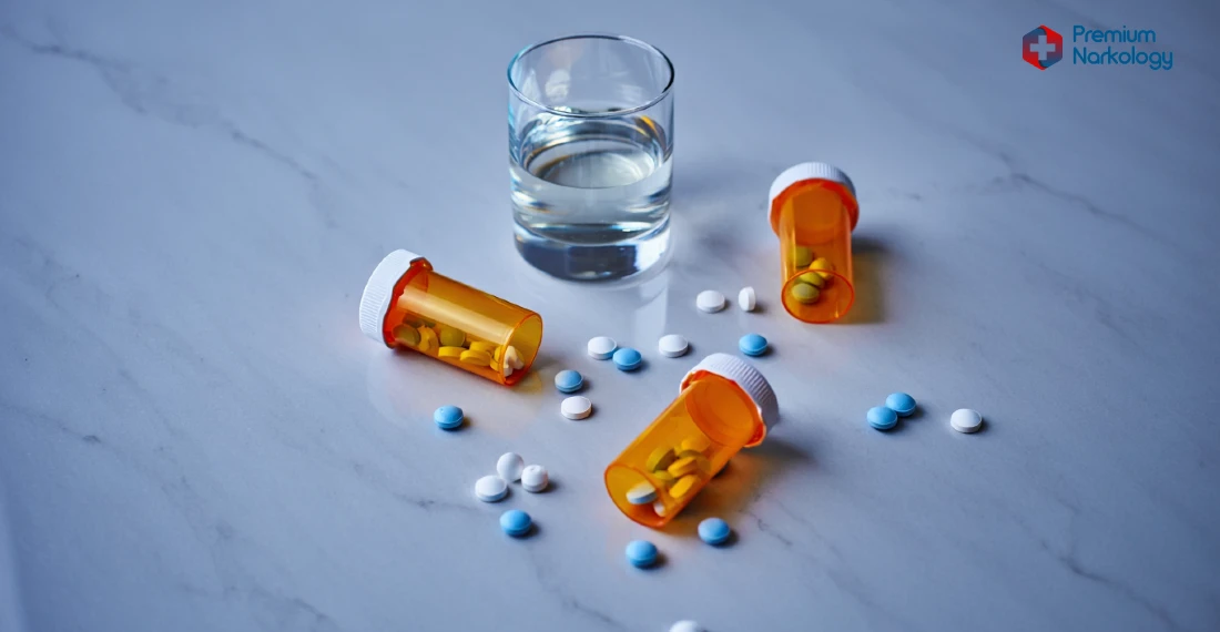 Мужчина со стаканом алкоголя и таблетками